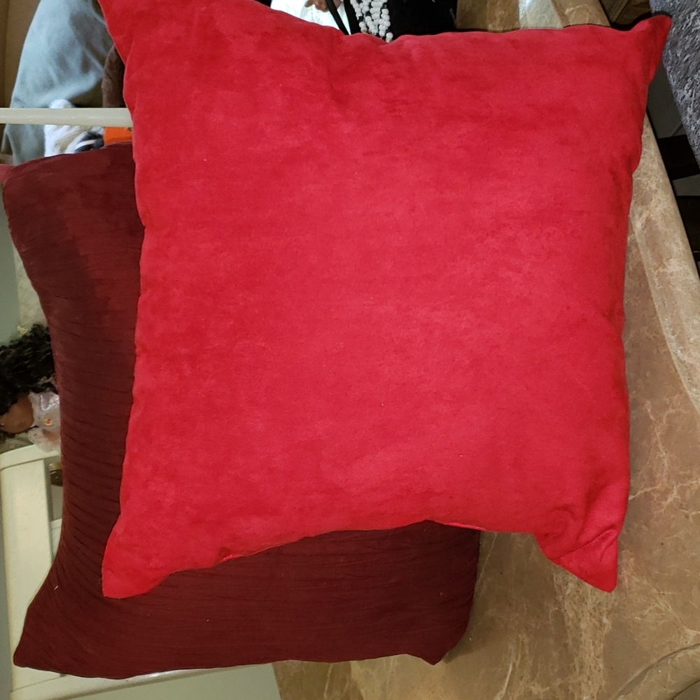 2 Pillows one red, and purple.